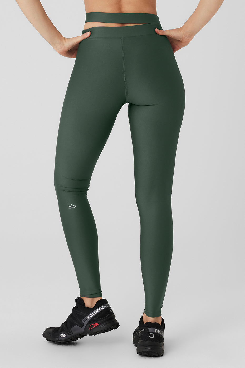 Model showcasing Airlift High-Waist All Access Legging in green, featuring cutout strap detail and sculpting micro-performance fabric.
