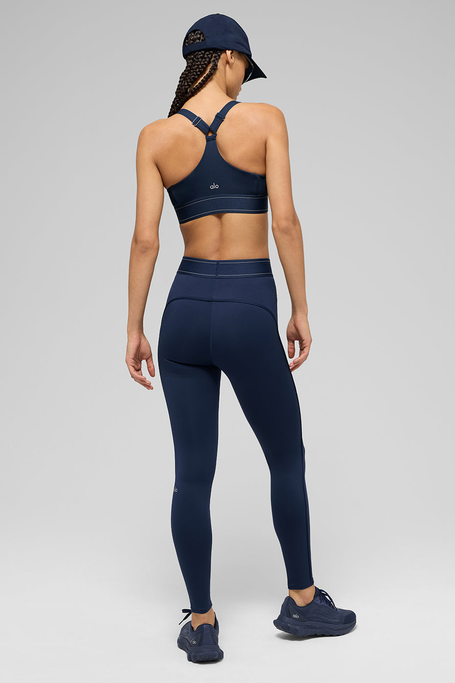 Model wearing Airlift high-waist Suit Up leggings with matching sports bra, showcasing boxer-style waistband and full-length fit.