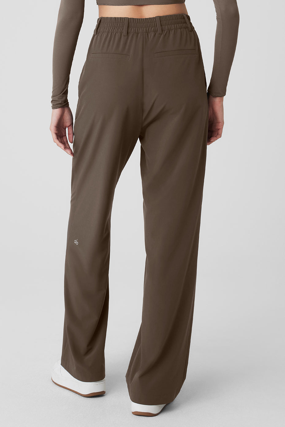Back view of high-waist pursuit trousers showcasing relaxed wide-leg fit and stretchy waistband.