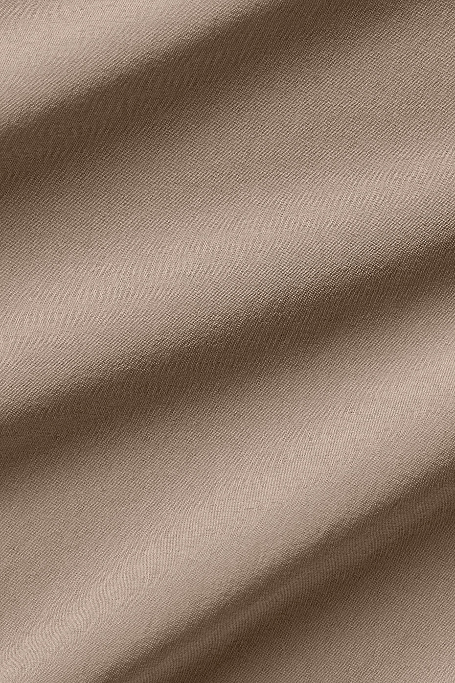 Close-up of lightweight stretch-infused fabric in soft neutral tone, ideal for modern fit high-waist trousers.