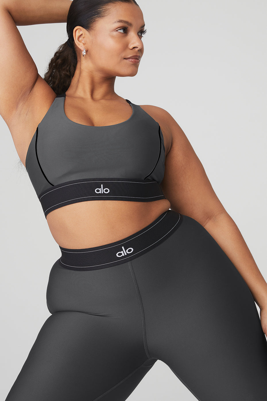 Model wearing Airlift High-Waist Suit Up Legging with matching bra, showcasing body-contouring design and high-compression fabric.