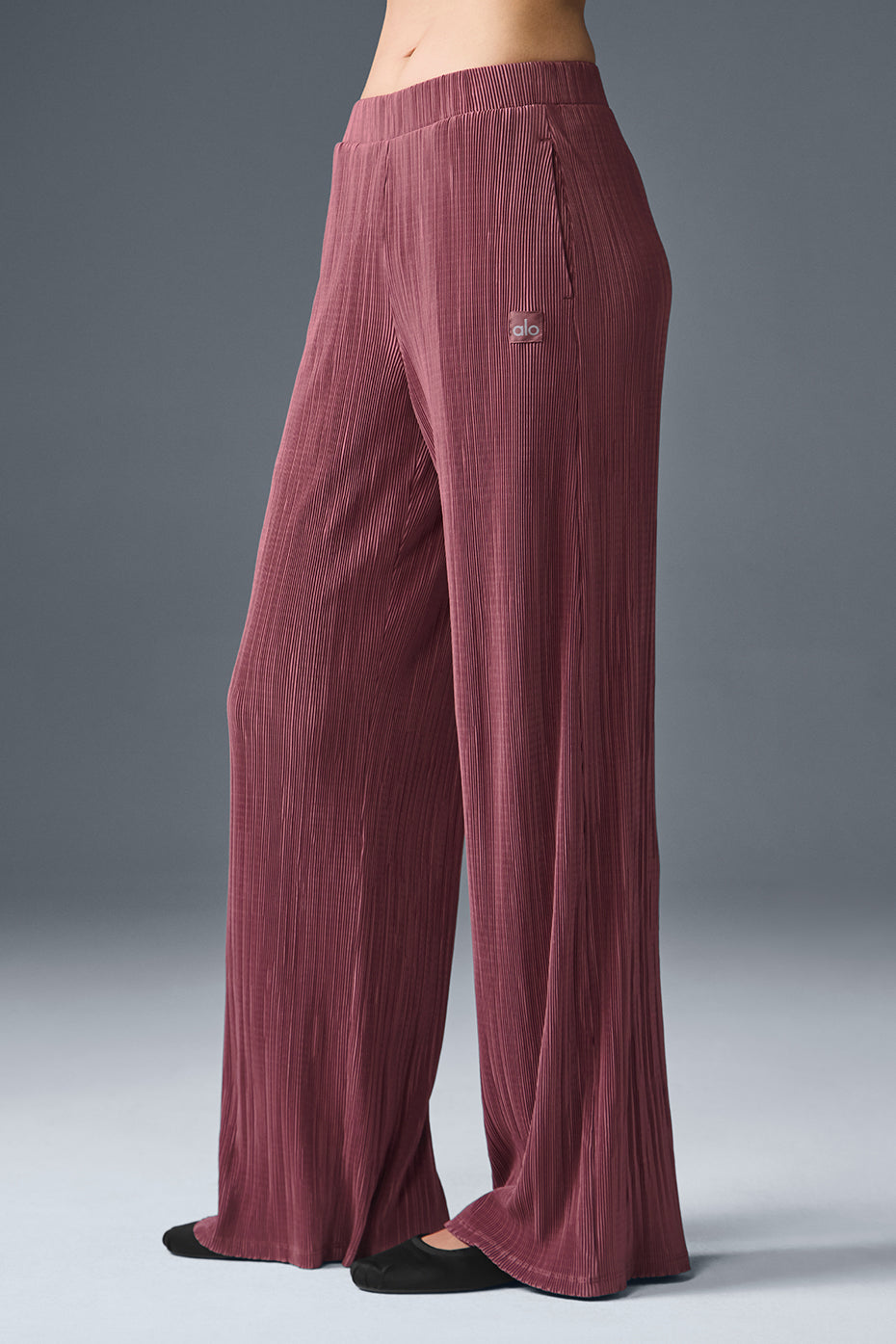 High-waist micro plisse straight leg pant in maroon with relaxed fit and soft crinkly texture, puddling at the ankle.
