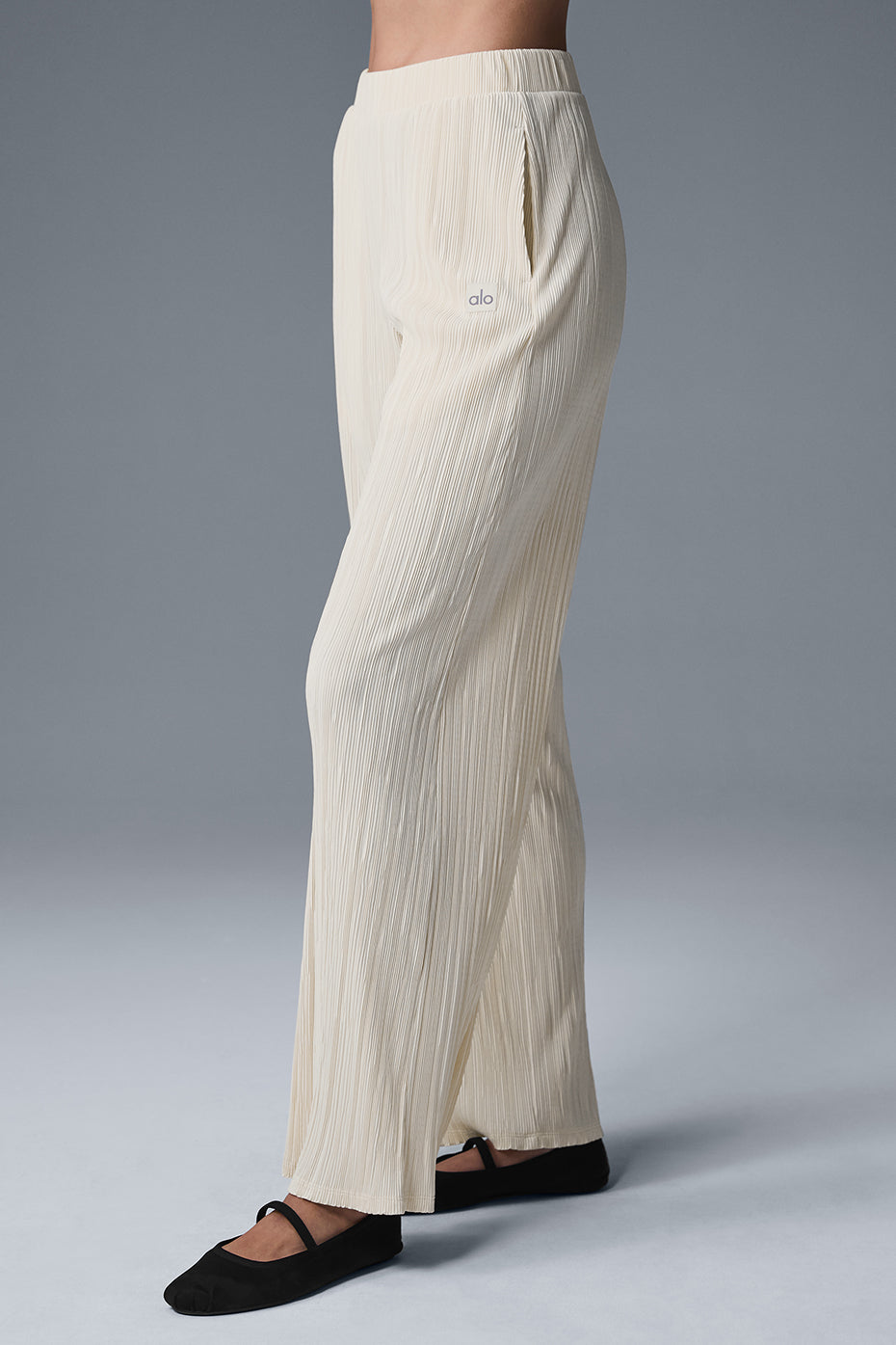 High-waist micro plisse straight leg pant in beige with a relaxed fit and soft, crinkly mini-pleat texture.
