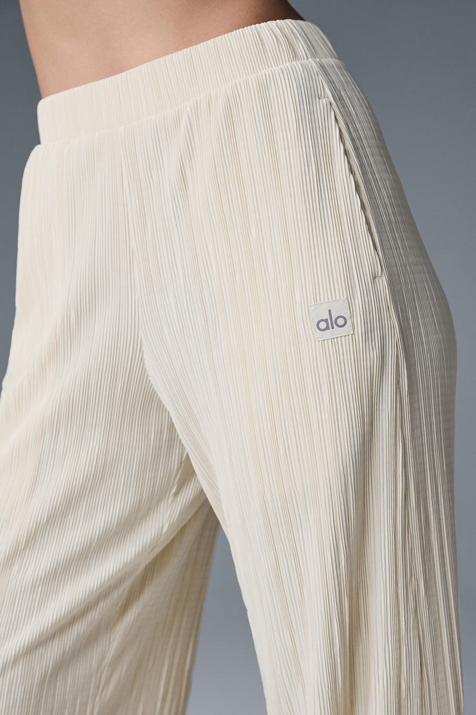 High-waist micro plisse straight leg pant featuring a relaxed fit and soft mini-pleat texture for elevated comfort.