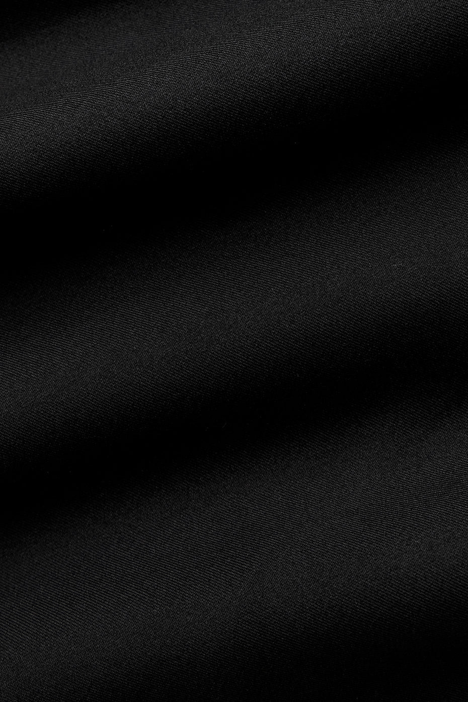 Close-up of soft black fabric ideal for leggings, showcasing the sleek texture and high-quality material.