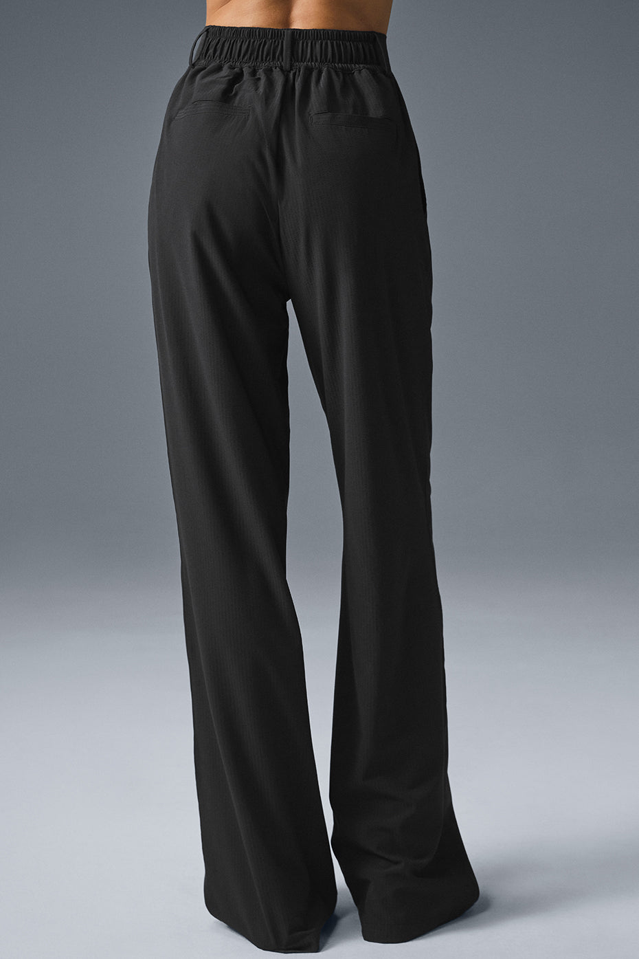 Back view of High-Waist Dreamscape Trouser in black, featuring a relaxed fit and lightweight crinkle woven fabric.