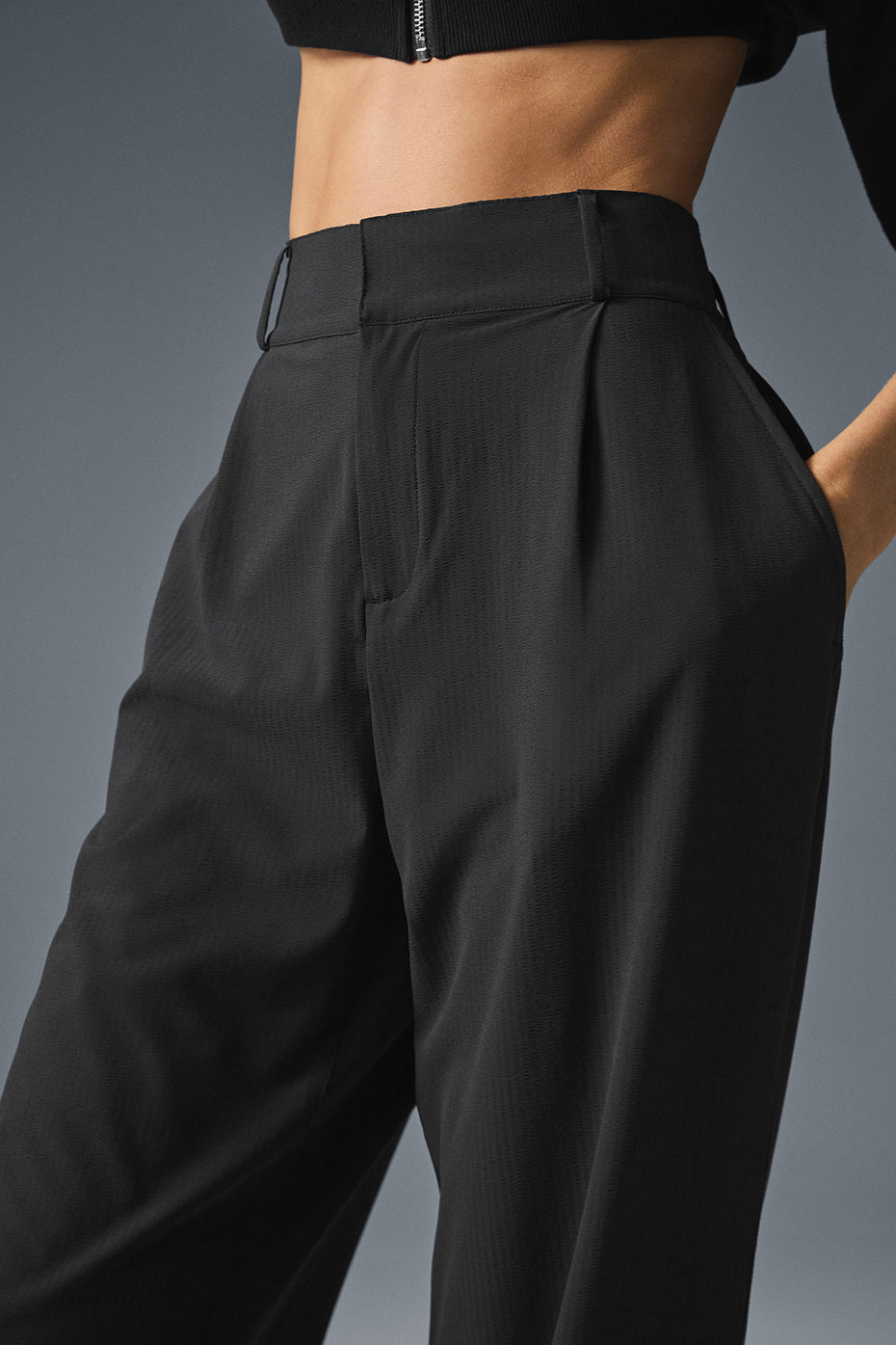 High-Waist Dreamscape Trouser in black with pleats and belt detail, showcasing a stylish silhouette and lightweight fabric.
