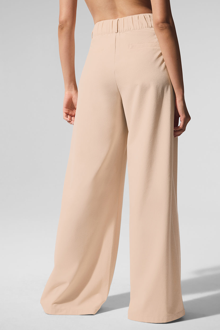 Back view of High-Waist Dreamscape Trouser in lightweight crinkle woven fabric, showcasing a flowy and stylish fit.