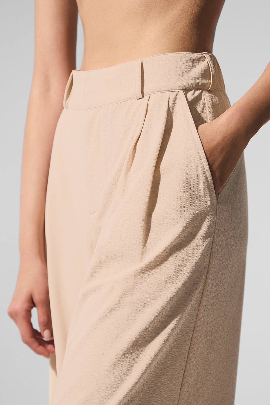 Close-up of High-Waist Dreamscape Trouser showcasing pleats and pockets in lightweight fabric.