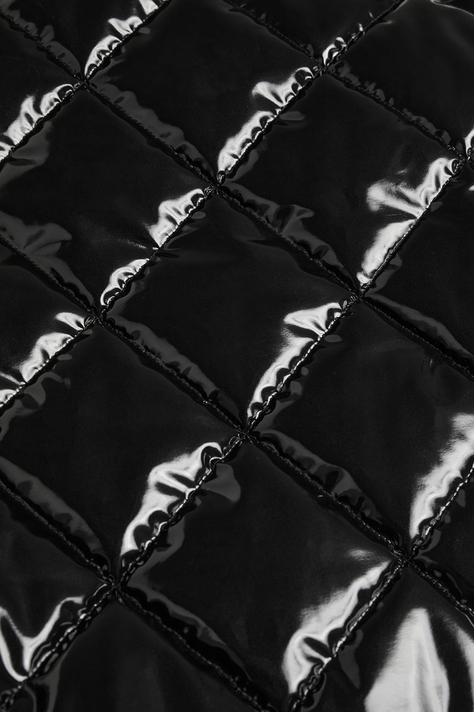 Quilted high-shine fabric texture of Snomoto Puffer Mini Skirt showcasing its stylish design and warmth.