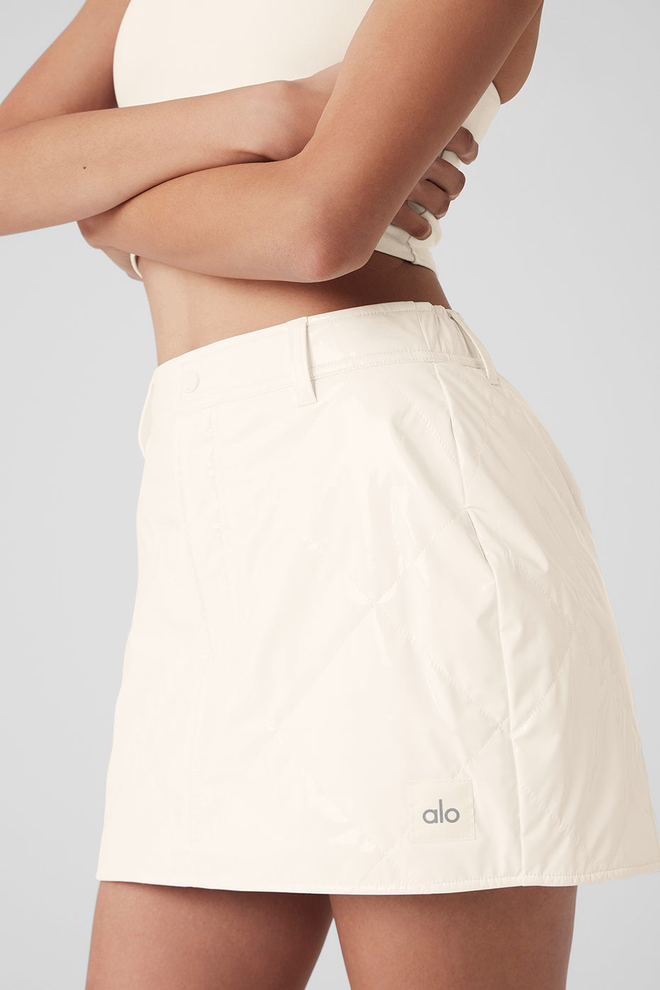 Snomoto Puffer Mini Skirt in high-shine fabric, quilted finish, mid-thigh length with a high-rise waistband.