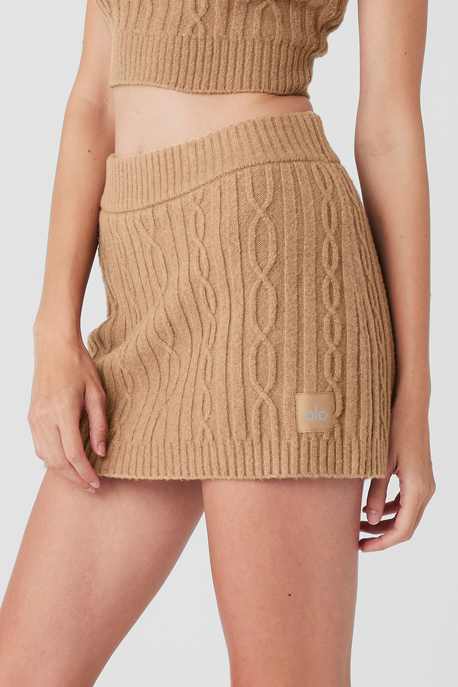 Cable Knit Winter Bliss Mini Skirt in soft beige fabric with an elastic waistband, styled for a cozy winter look.