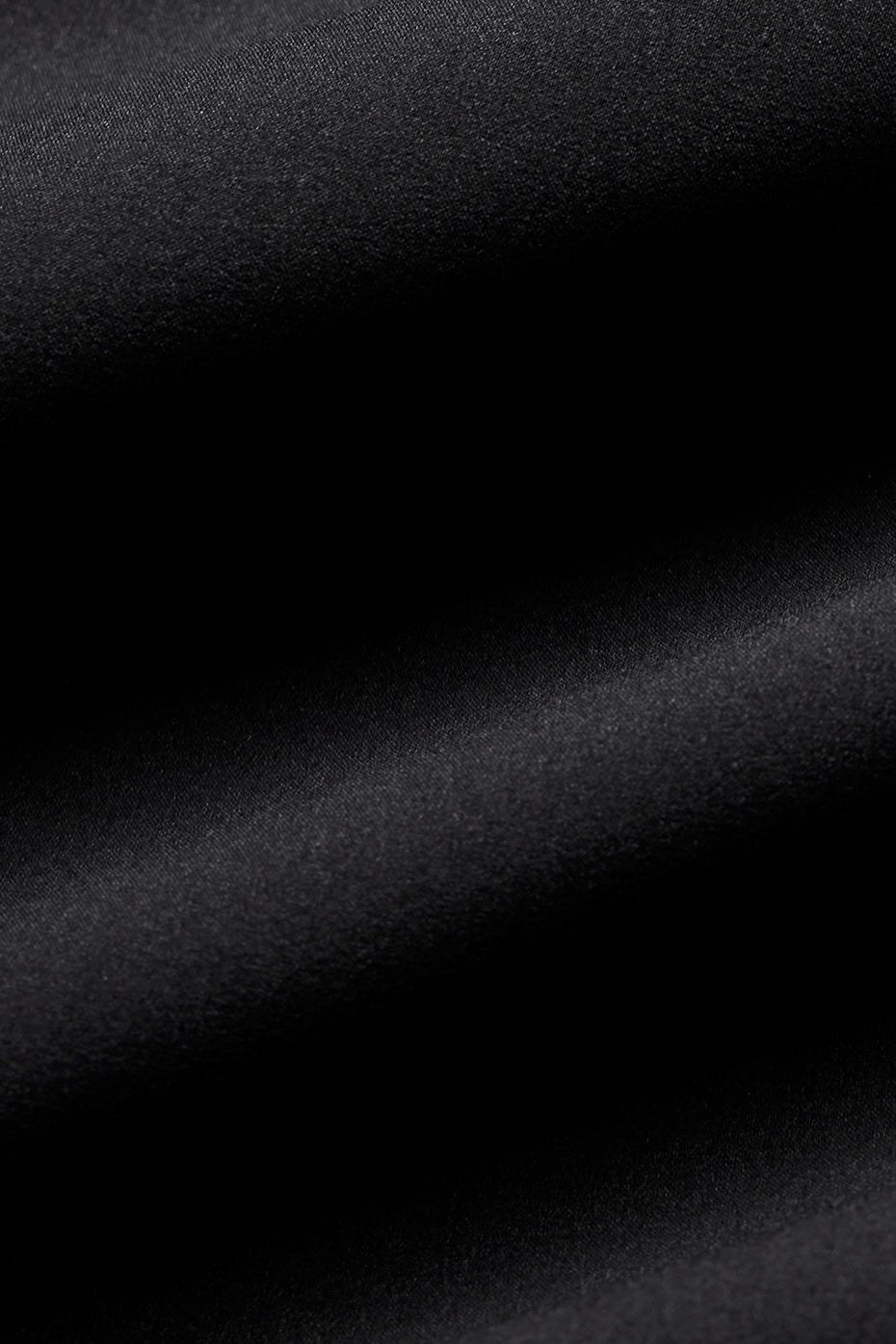 Close-up of textured black fabric used in Playmaker Dolphin Short, showcasing its sporty and stretchy qualities.