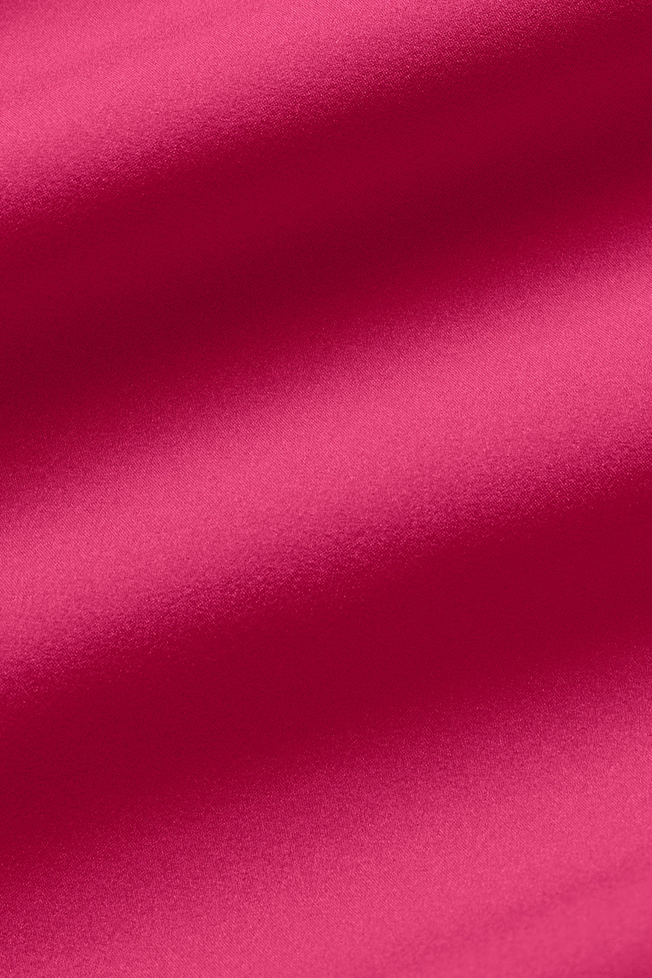 Close-up of vibrant pink fabric showcasing a soft, slightly stretchy texture ideal for sporty shorts.
