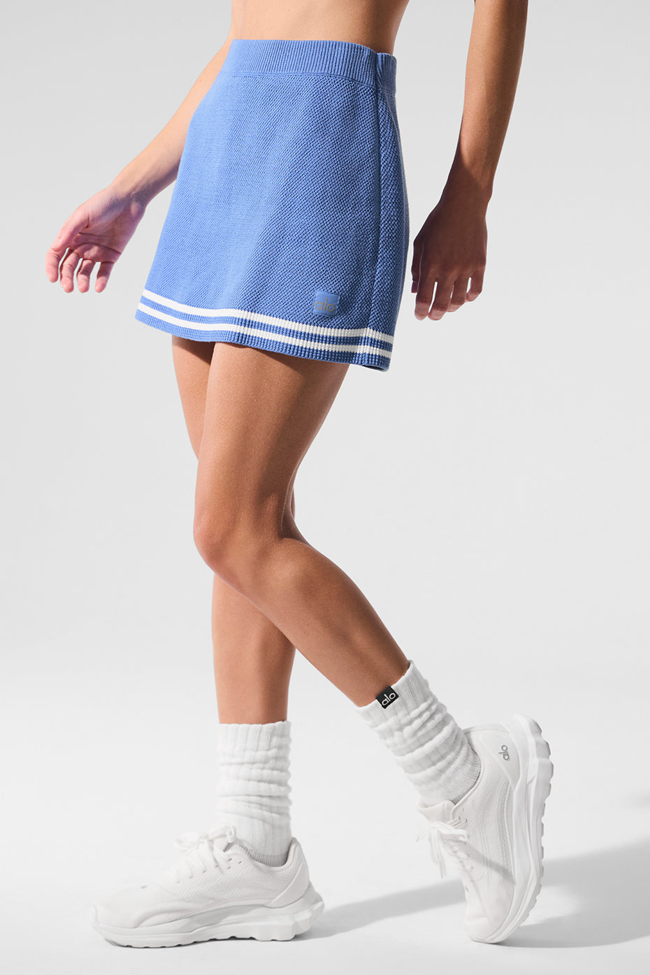Tennis Club Sweater Knit Skirt featuring high-rise waist, A-line fit, and collegiate stripes in blue.