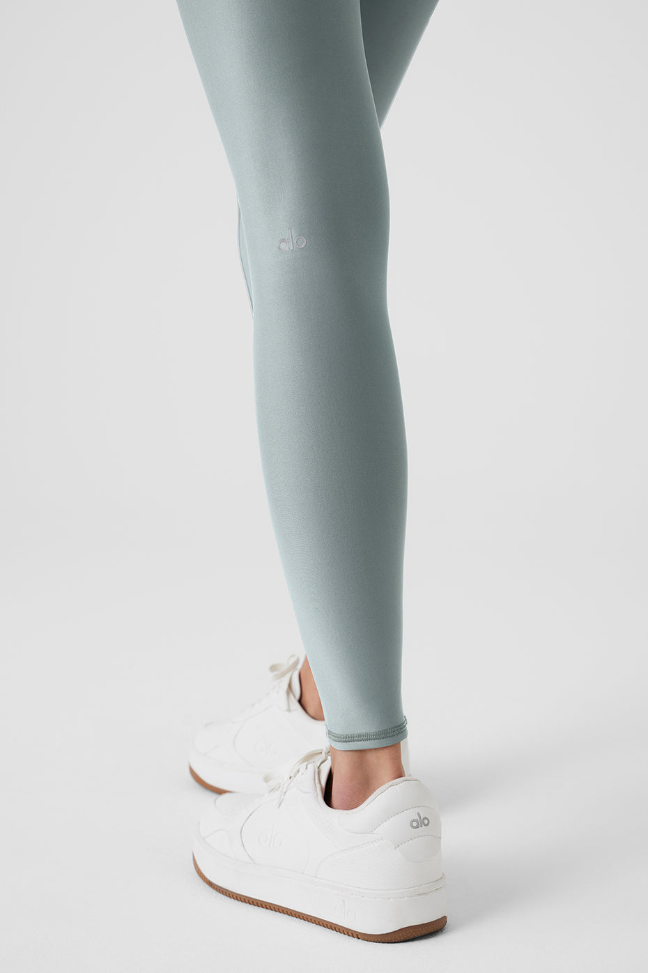 Airlift Winter Warm High-Waist Legging in light blue, paired with white sneakers, showcasing a second-skin fit.