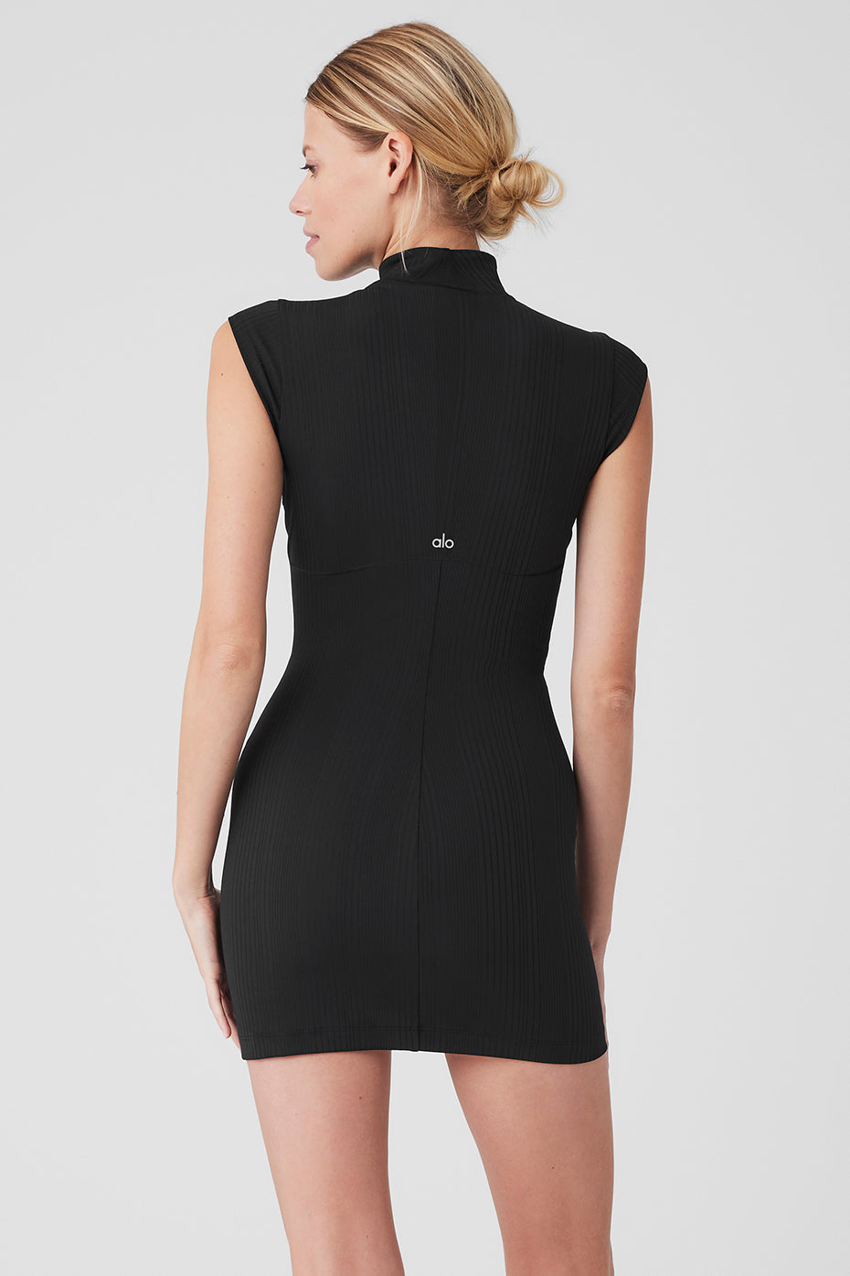Back view of the Run It Back Dress featuring a mock neck and sleeveless design in a ribbed finish for a flattering look.