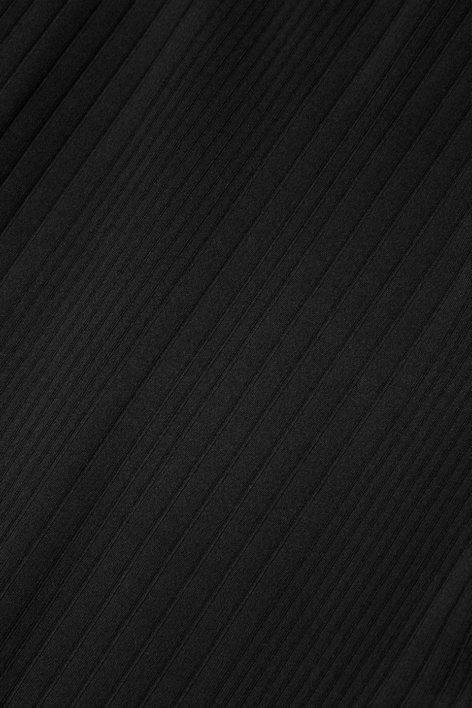 Close-up of subtly ribbed black fabric, perfect for a flattering and comfortable dress with a vintage vibe.