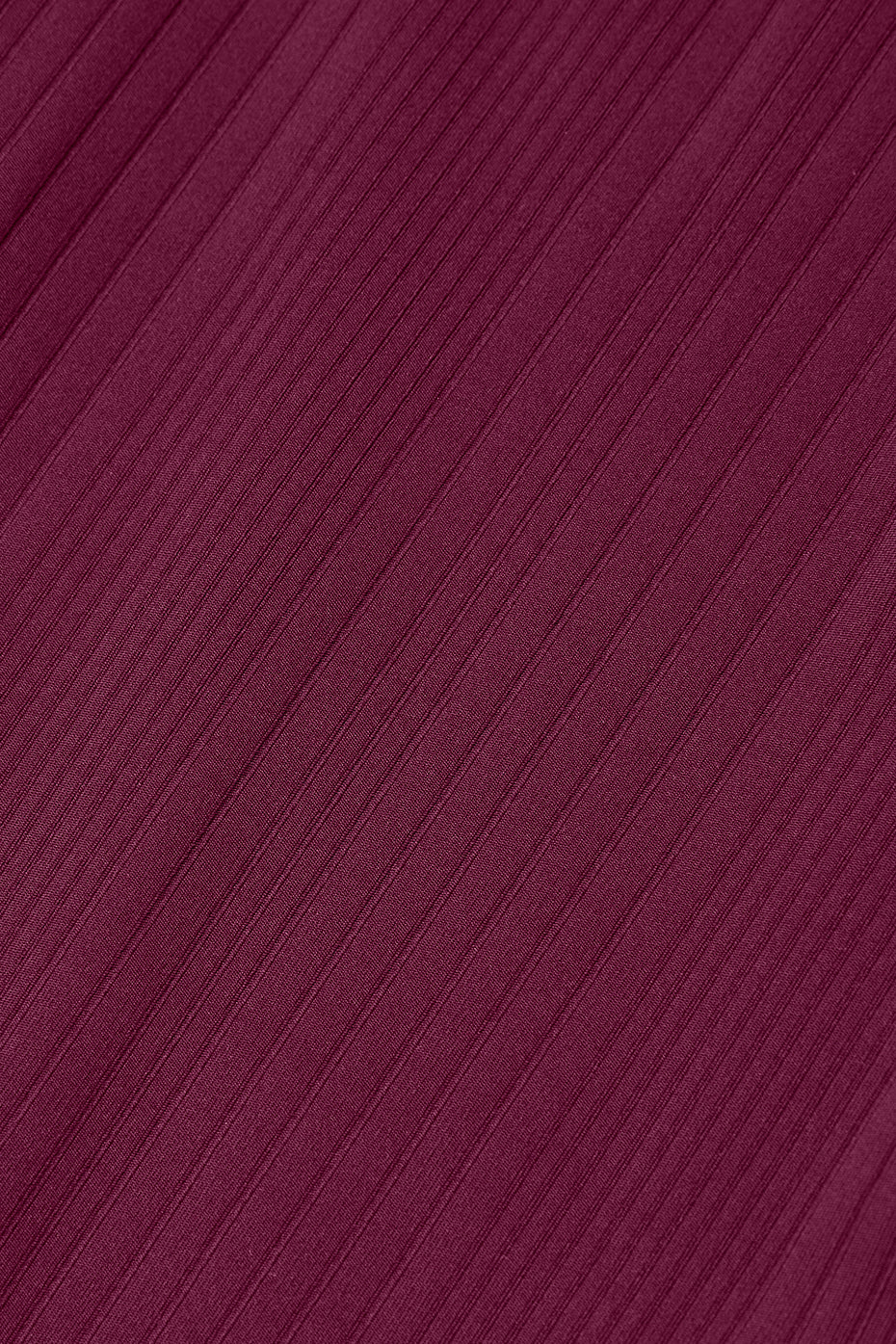 Close-up of ribbed fabric in deep burgundy, showcasing the texture and versatile style inspired by the Run It Back Dress.