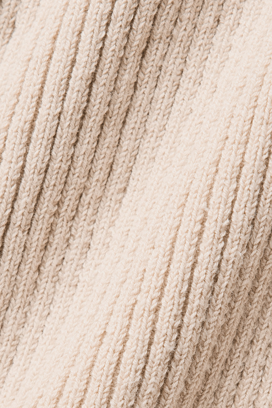 Close-up of lightweight knit fabric in a beige hue for the Supernatural Sweater Dress, highlighting its breathable texture.