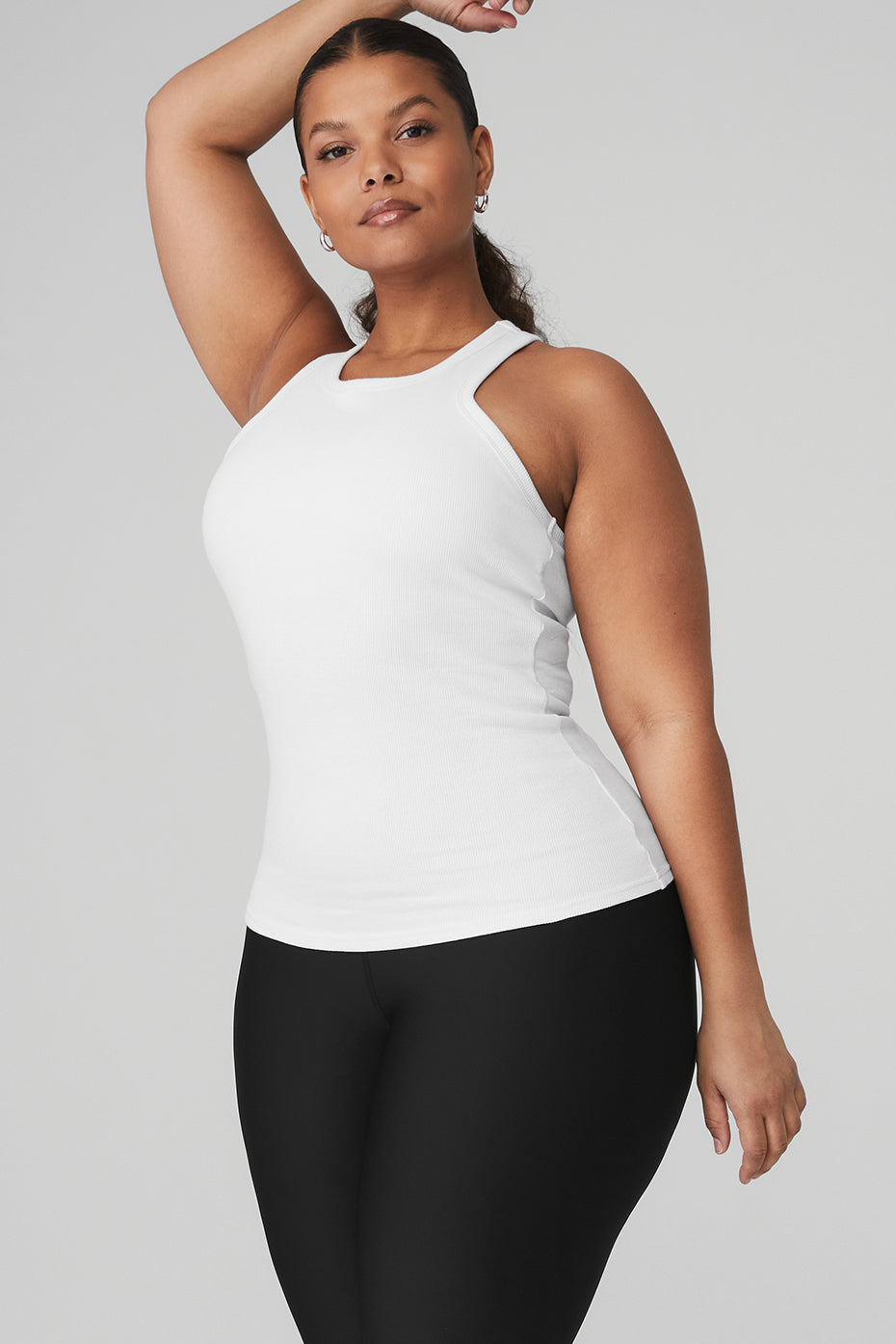Model wearing the Ribbed Aspire Full Length Tank in white, showcasing its high-neck design and racerback style.