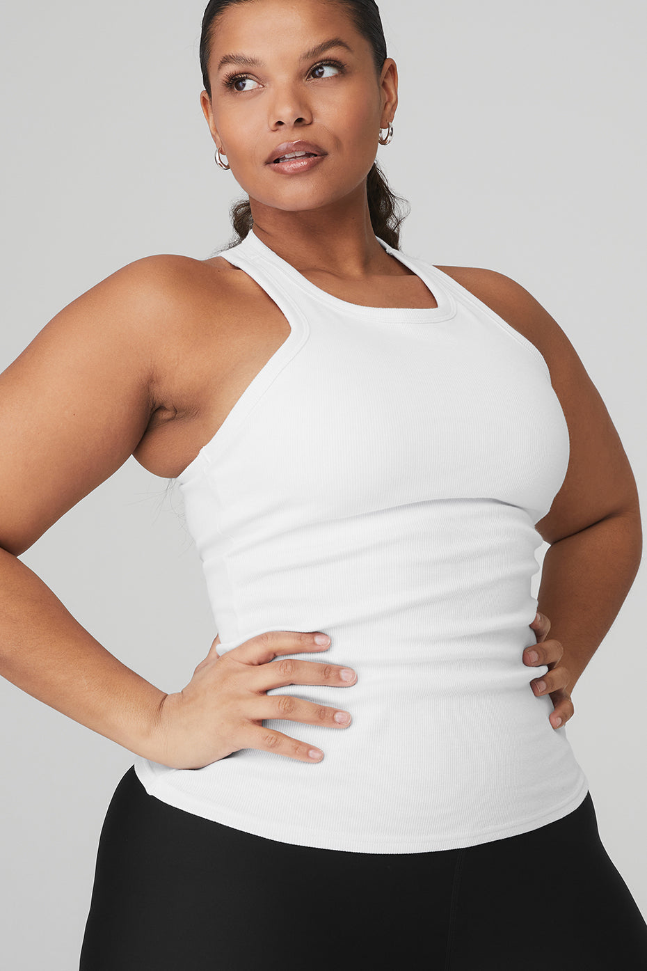 Model showcasing the Ribbed Aspire Full Length Tank in white, highlighting its high-neck and racerback design for versatile layering.