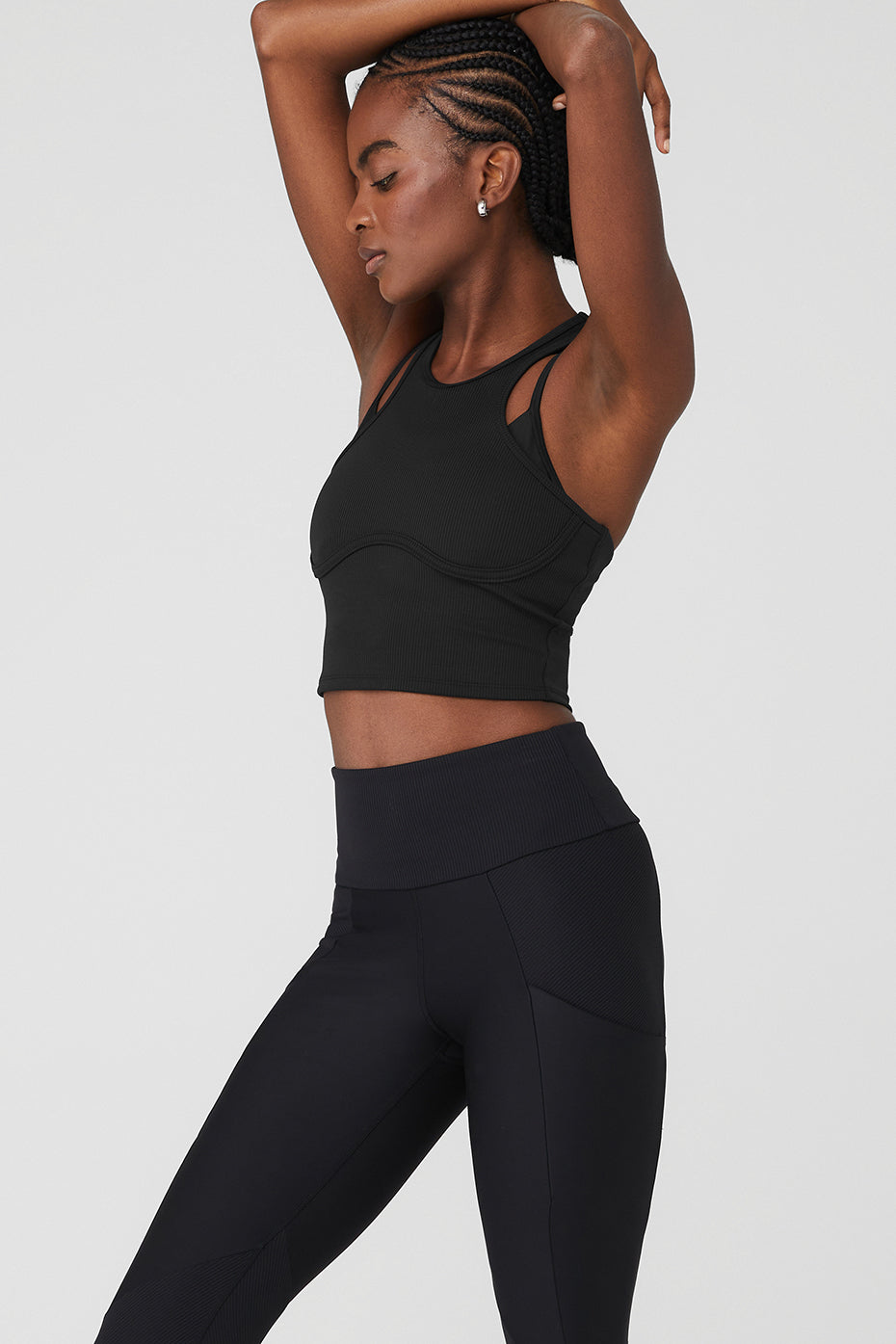 Model wearing Ribbed Airlift Enchanted Bra Tank with double crisscross straps and high-waist performance leggings.
