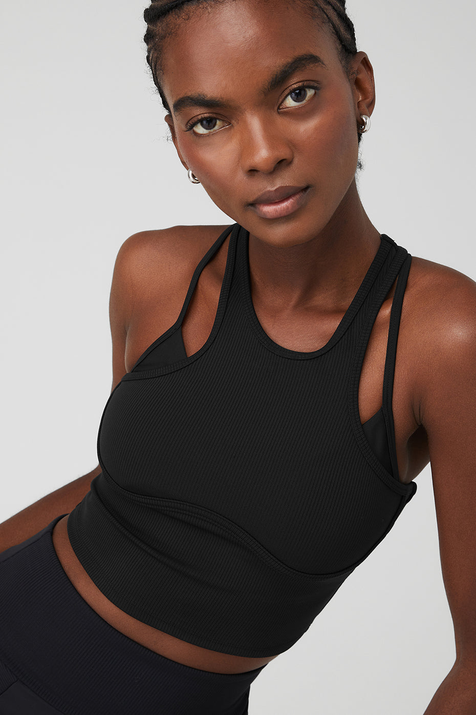 Model showcasing the Ribbed Airlift Enchanted Bra Tank with adjustable double straps and a sleek design.