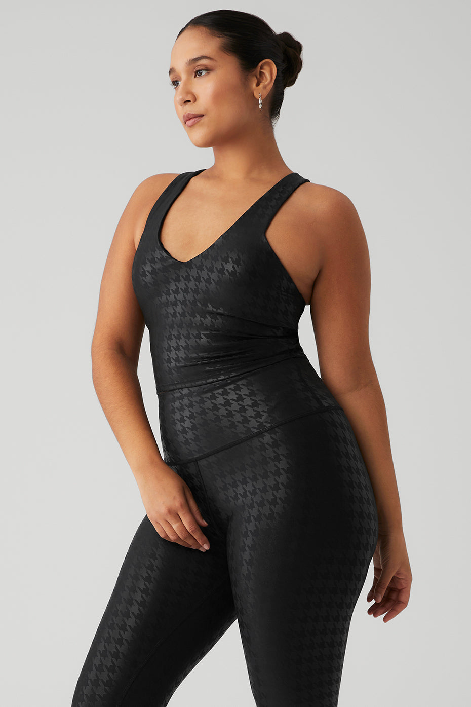 Model wearing Airlift Glimmer Houndstooth Real Bra Tank showcasing sleek design and tonal houndstooth print.