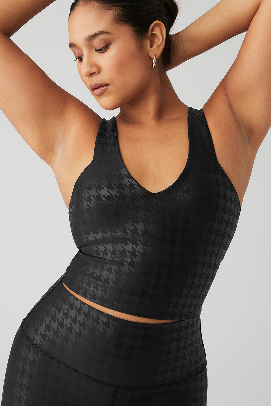 Model wearing Airlift Glimmer Houndstooth Real Bra Tank showcasing sleek design and tonal houndstooth pattern