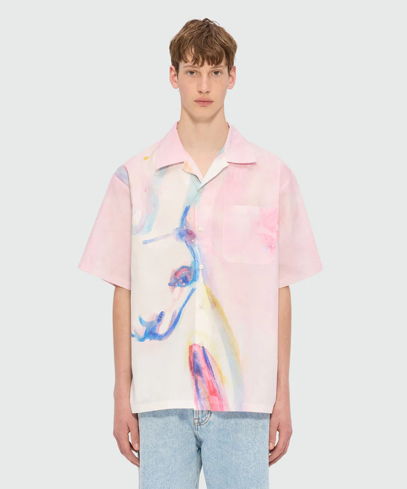 Pink poplin bowling shirt with The White Rabbit print, featuring a patch pocket and oversized fit, modeled by a young man.