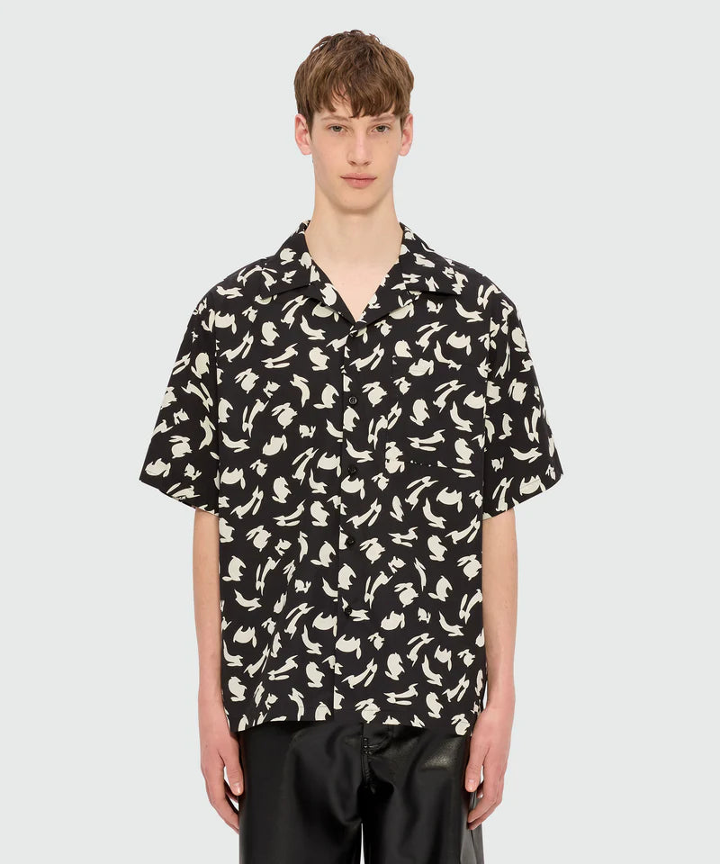 Black poplin bowling shirt with Follow the Rabbit print on model featuring oversized fit and chest pocket.