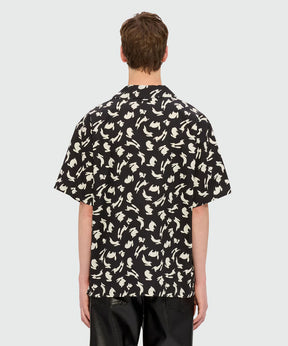 Black poplin oversized bowling shirt featuring "Follow the Rabbit®" print, shown from the back.