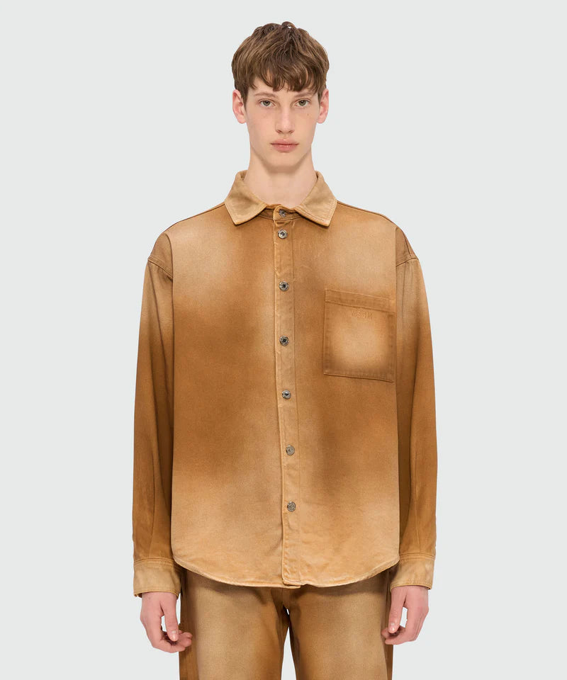 Beige spray-effect denim shirt with classic collar and front button closure, featuring chest pocket and oversized fit.