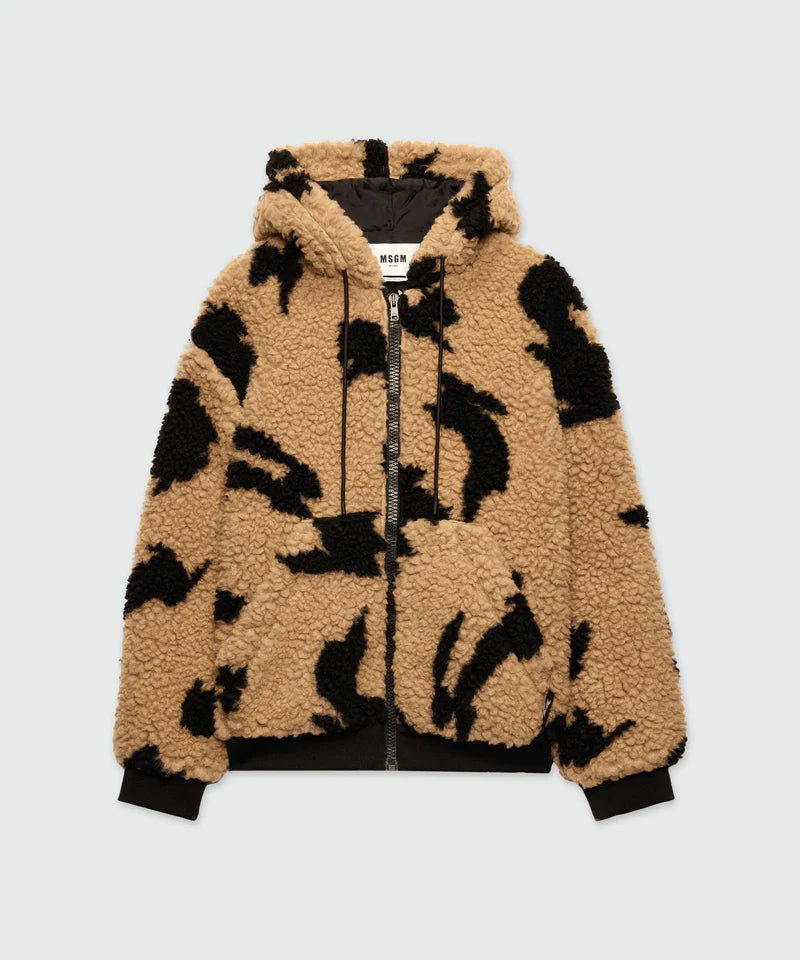 Beige teddy jacket with black motifs, drawstring hood, front zip closure, and kangaroo pockets.
