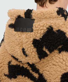 Beige teddy jacket with Follow the Rabbit motif, featuring hood and textured fabric, model showing back view.