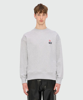 Grey melange jersey sweatshirt with MSGM Roses patch on chest, crewneck style, regular fit, model wearing size M/48.