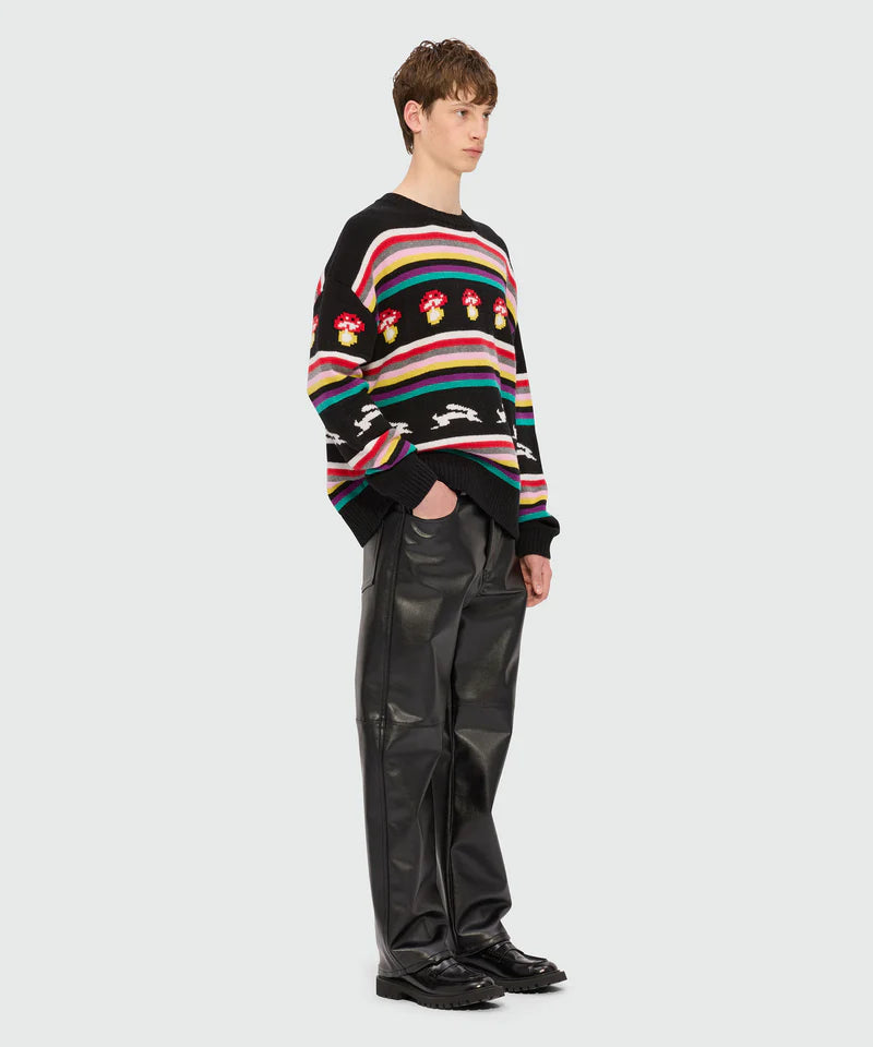 Oversized multicolor jacquard sweater with rainbow stripes and mushroom design, model wearing size M/48.