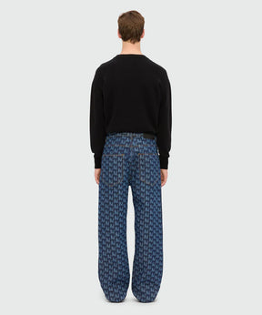 Back view of model wearing blue laser-cut denim trousers with TheMwave motif and oversized fit.