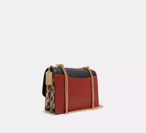 Klare Crossbody Bag In Signature Canvas With Rivets