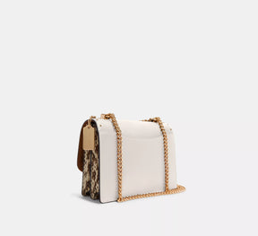 Klare Crossbody Bag In Signature Canvas With Rivets