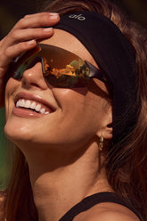 Model wearing sleek Airlift Headband and sunglasses, showcasing a stylish look for active lifestyles.