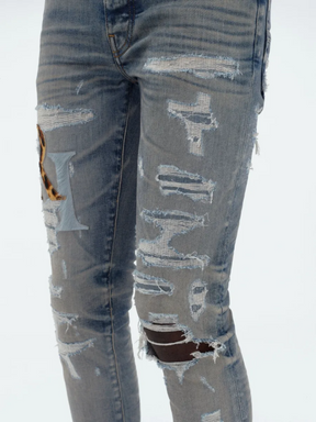 AMIRI STAGGERED LOGO JEANS INDIGO