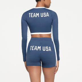 SKIMS FOR TEAM USA SIGNATURE SWIM OLYMPIC LONG SLEEVE CROPPED T-SHIRT | NAVY