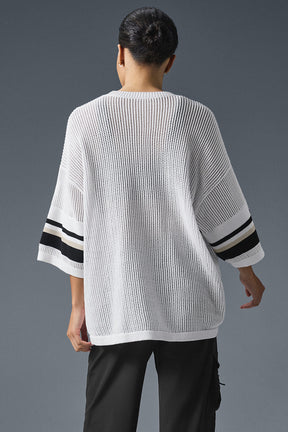 Back view of open knit playoff jersey with exaggerated arms and black stripes, ideal for stylish casual wear.