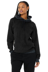 The Triumph Hoodie in black, featuring soft tri-blend fleece, drawstrings, and hidden zip pockets, perfect for yoga or lounging.