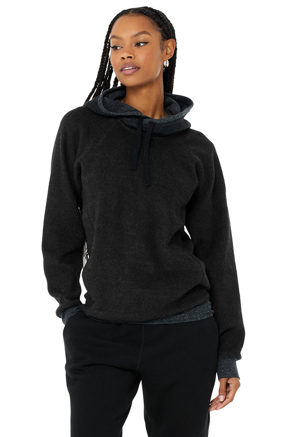 The Triumph Hoodie in black, featuring soft tri-blend fleece, drawstrings, and hidden zip pockets, perfect for yoga or lounging.