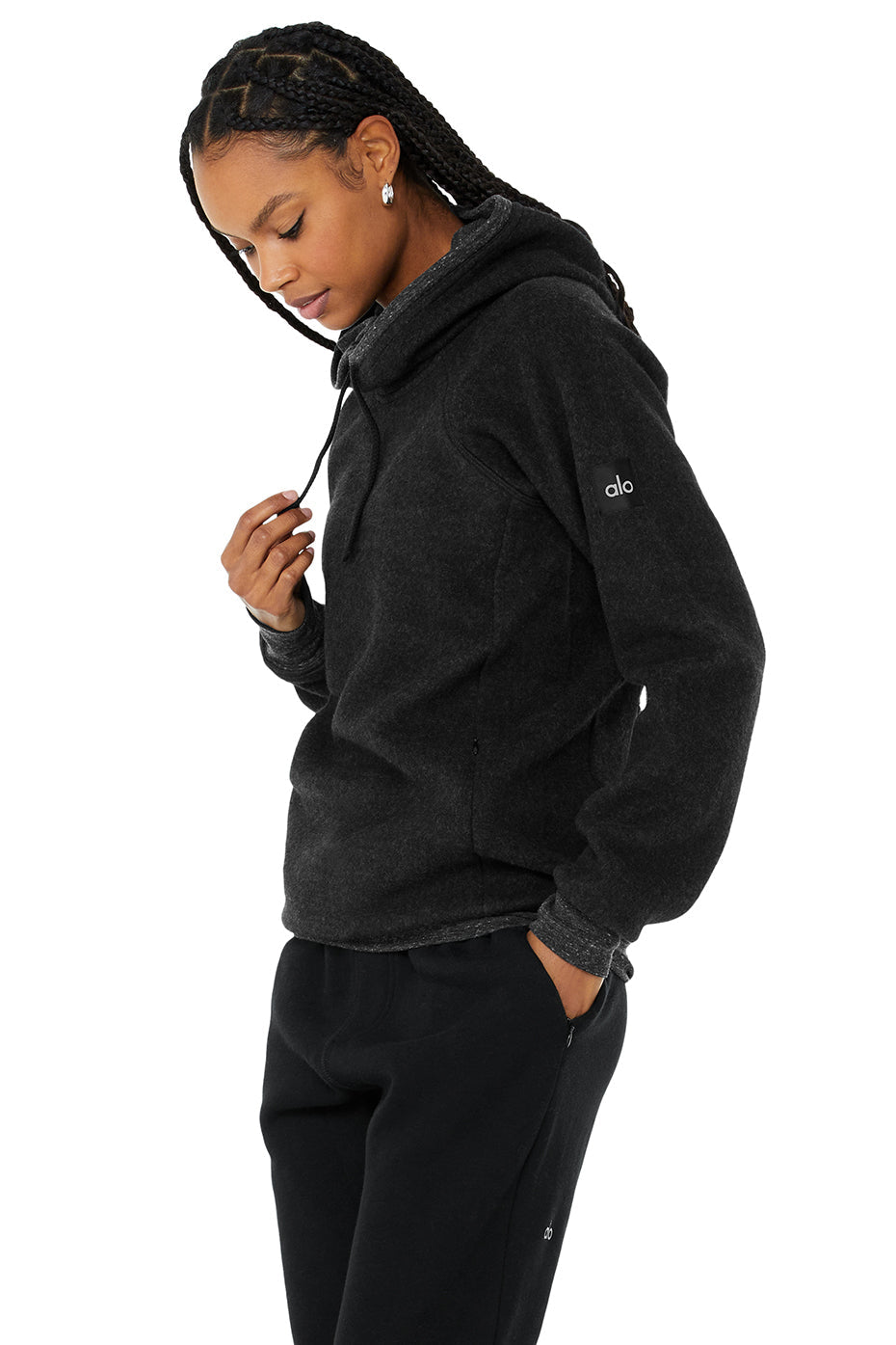 Model wearing a black Triumph Hoodie with hood, showcasing comfort and style for yoga or lounging.