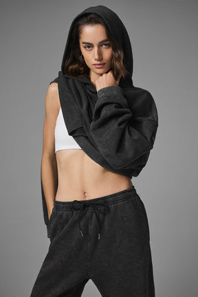Woman wearing a black Chill Vintage Wash Hoodie with a cropped fit and matching sweatpants for a casual weekend look.