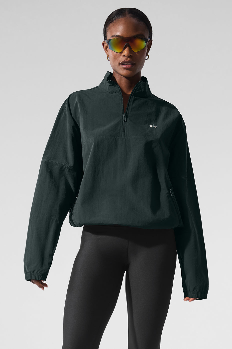 Light Weight Takeaway Track Pullover in dark green with quarter-zip neck and relaxed fit, styled with sunglasses.
